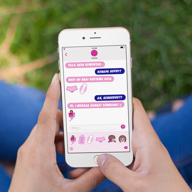 Image of a woman texting on her phone and using the Femoji app - Libresse